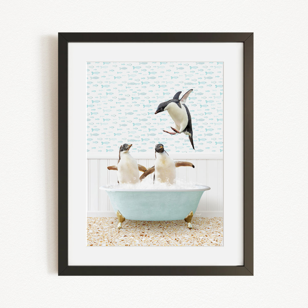 A framed image depicting two penguins sitting in a bathtub, with one penguin flying towards the other.
