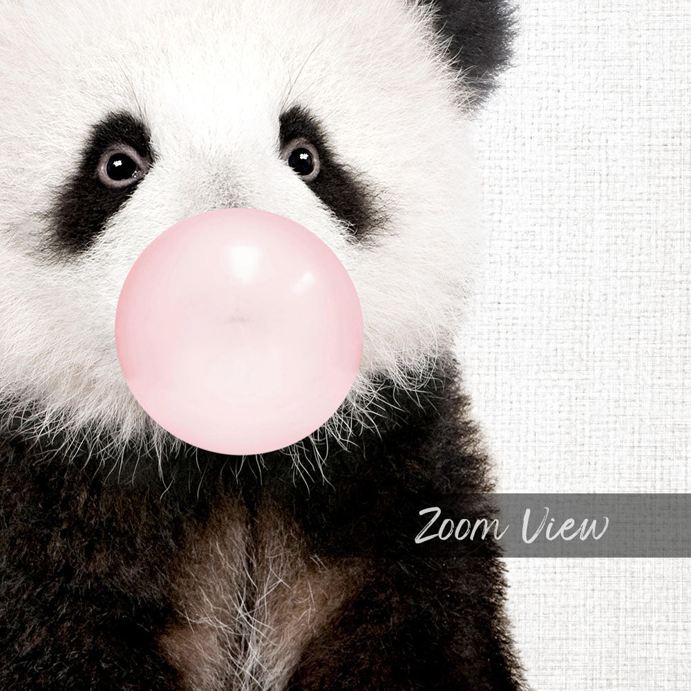 A close-up of a panda bear blowing a bubble with a pink bubble gum bubble.