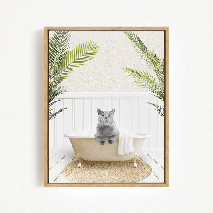 A gray cat sitting in a white bathtub, surrounded by green palm leaves, creating a serene and relaxing scene.