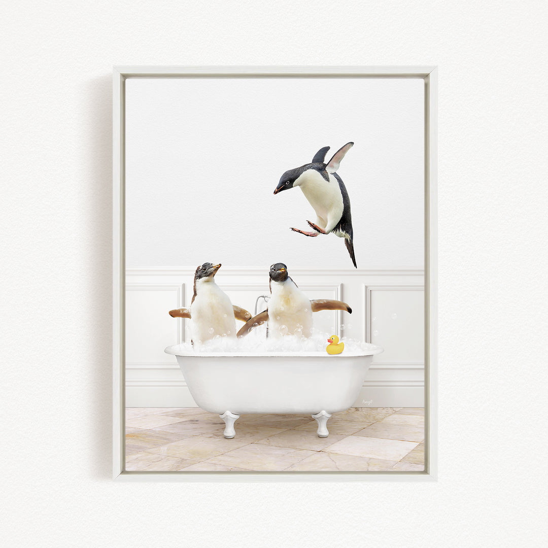 A framed image depicting two penguins sitting in a bathtub, with one penguin jumping out of the tub and another penguin sitting in the tub.