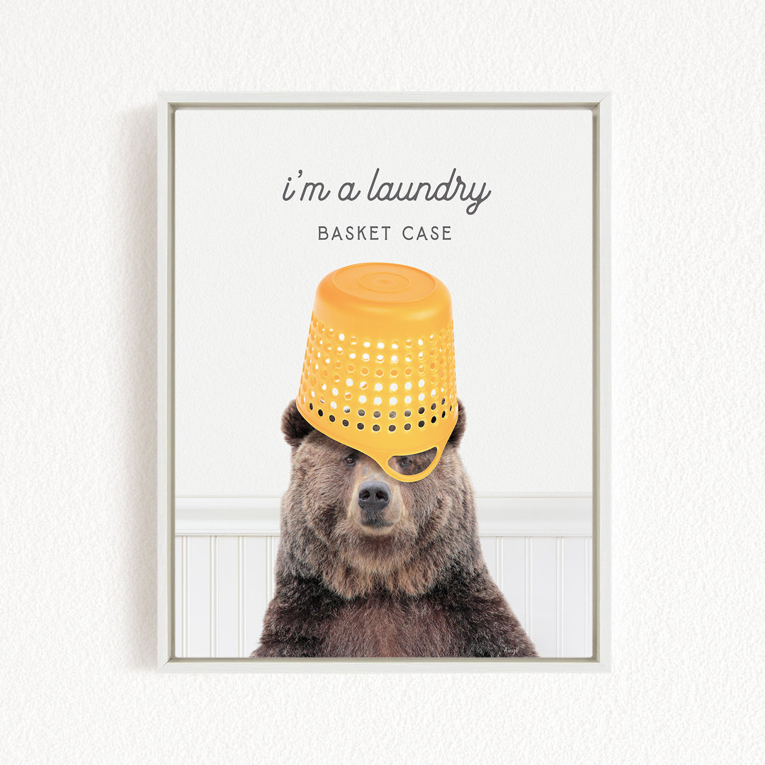 A brown bear wearing a yellow plastic bucket on its head, with the caption "I'm a laundry basket case" above the bear.