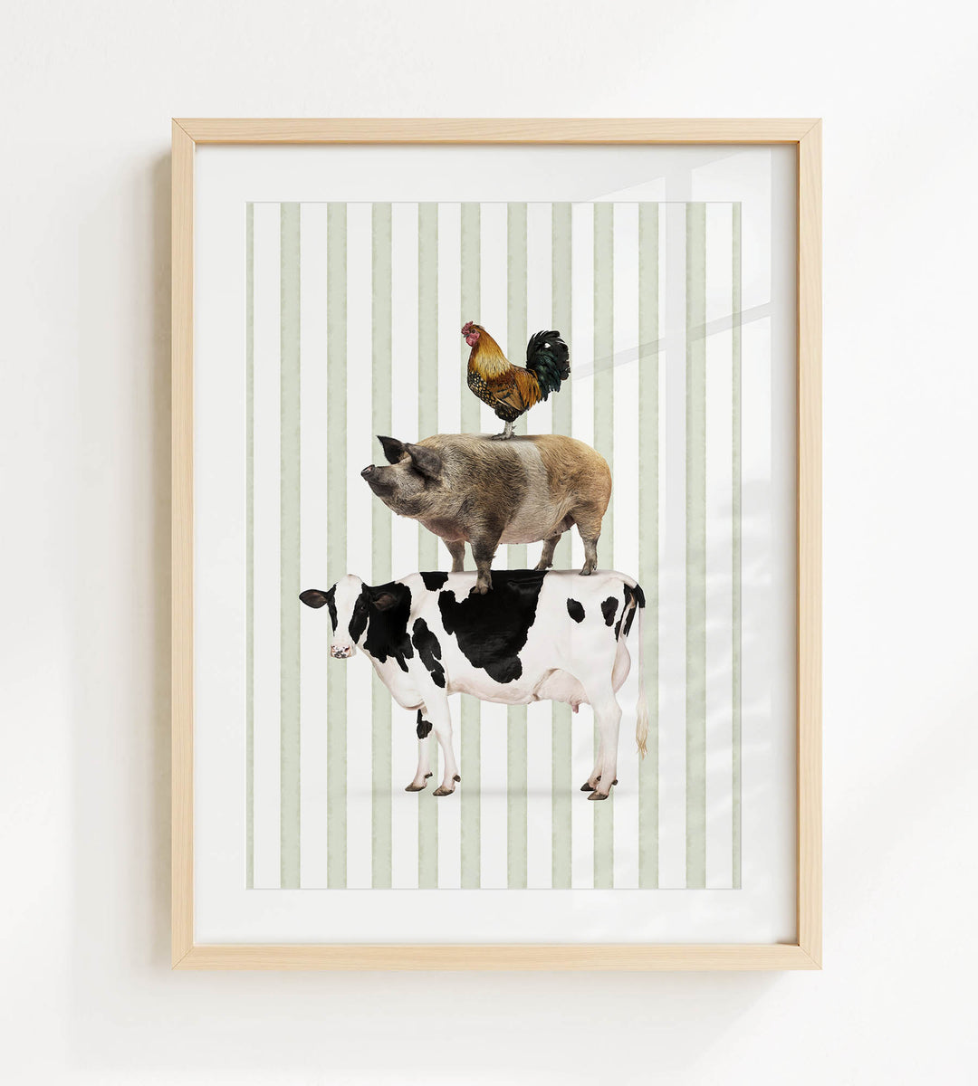 A framed collage of a pig, cow, and rooster, all standing on top of each other.