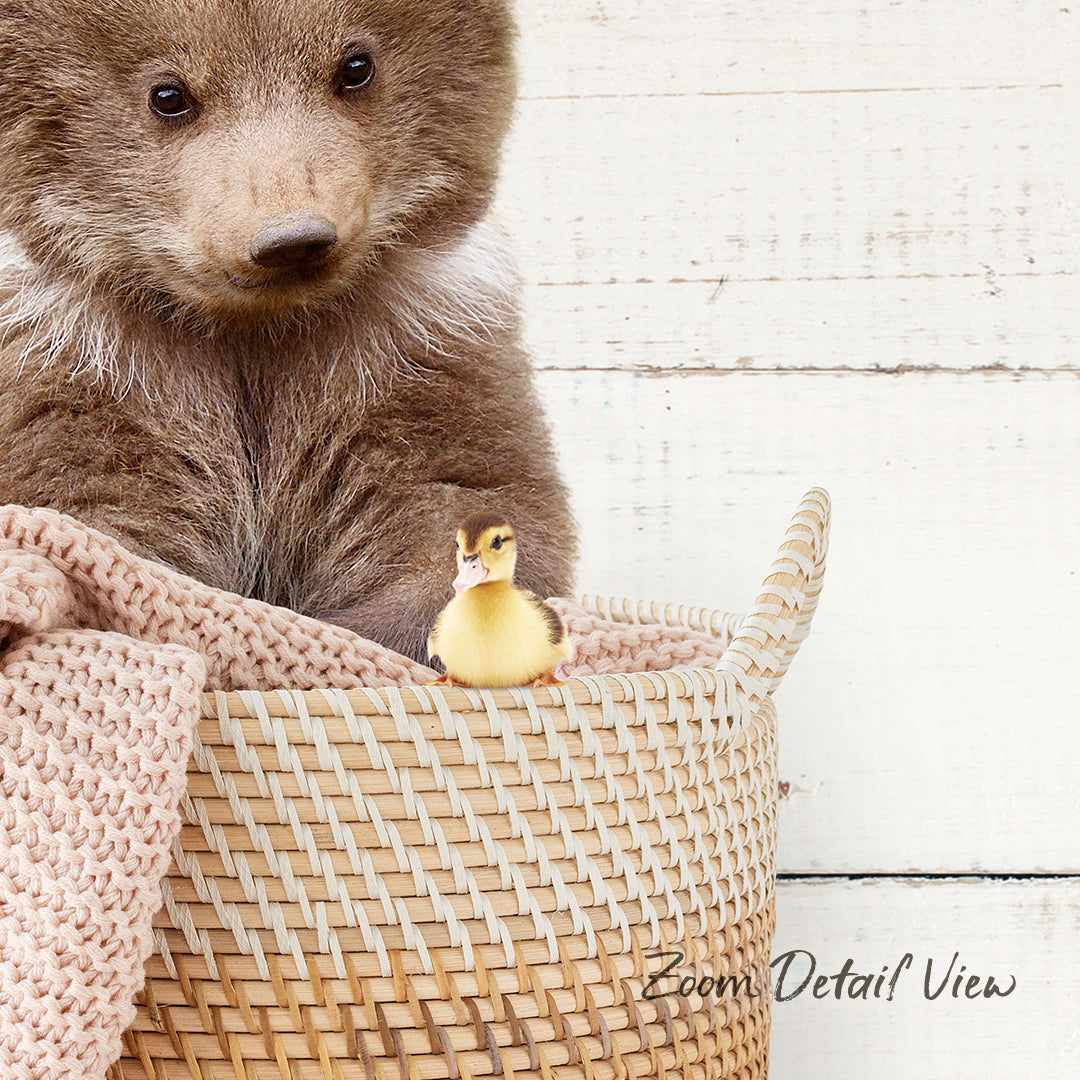 A brown bear sits in a woven basket, with a small yellow duck perched on the edge of the basket.