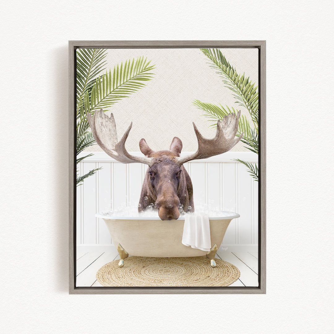A moose with large antlers is sitting in a bathtub filled with water, surrounded by green plants.