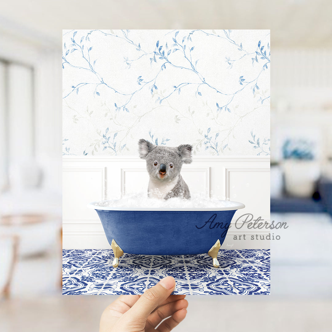 a hand holding a card with a picture of a koala in a bathtub