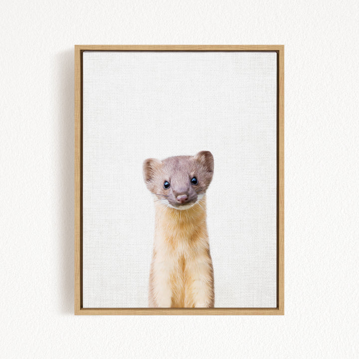 A small, furry animal with a curious expression is the focus of the image, which is framed and displayed on a white wall.