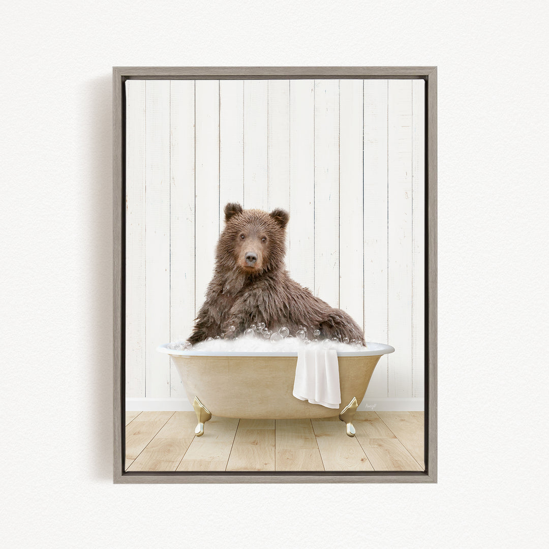 A brown bear sitting in a bathtub filled with water, surrounded by a white wooden wall.