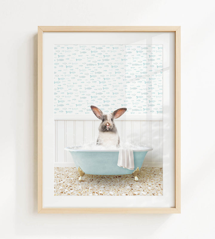 A rabbit sitting in a blue bathtub filled with bubbles, surrounded by a patterned wall and a window.