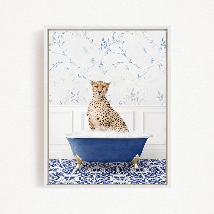 A cheetah sitting in a blue bathtub, surrounded by a blue and white patterned rug and a floral wallpaper background.
