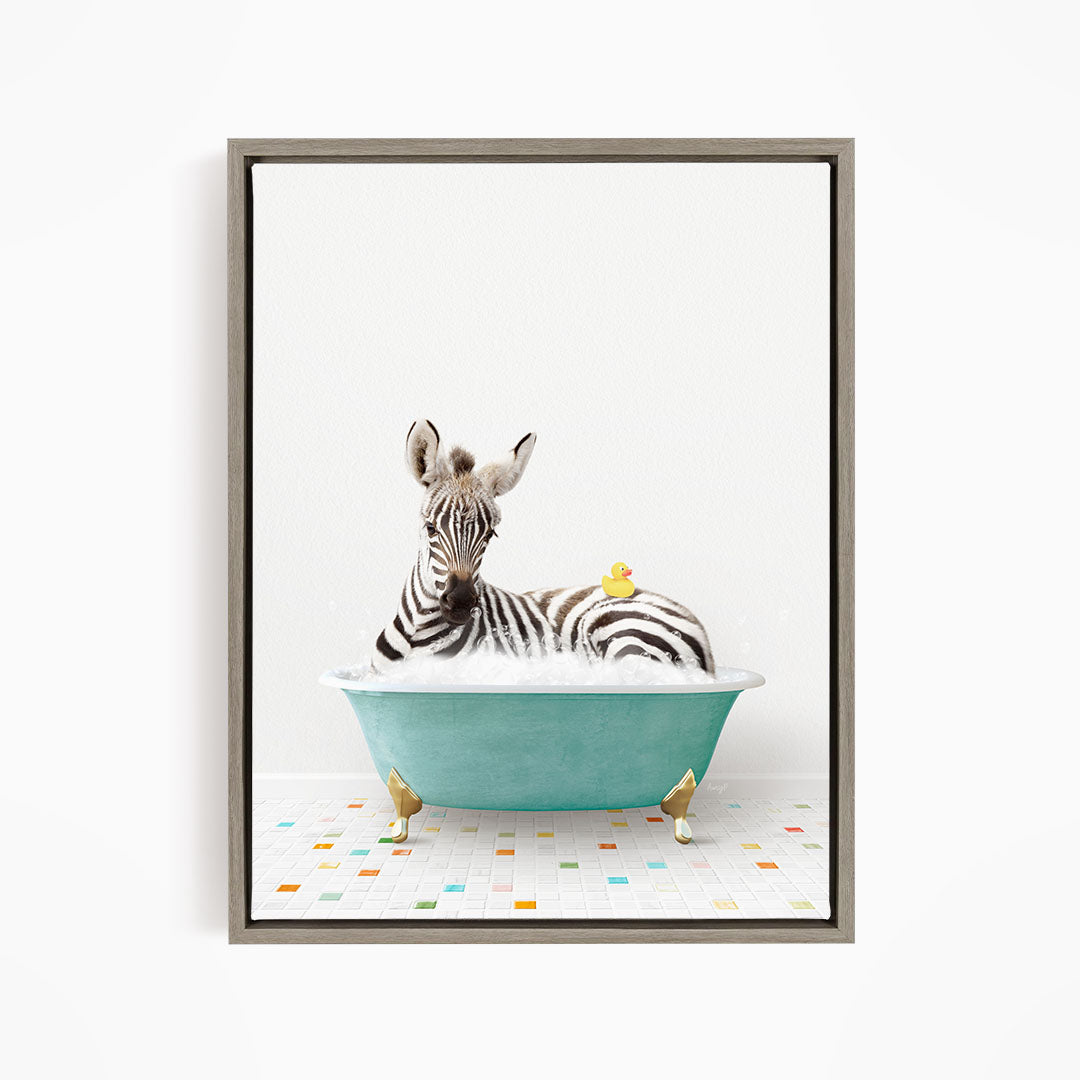 A zebra is sitting in a blue bathtub, with a yellow rubber duck floating on the water.