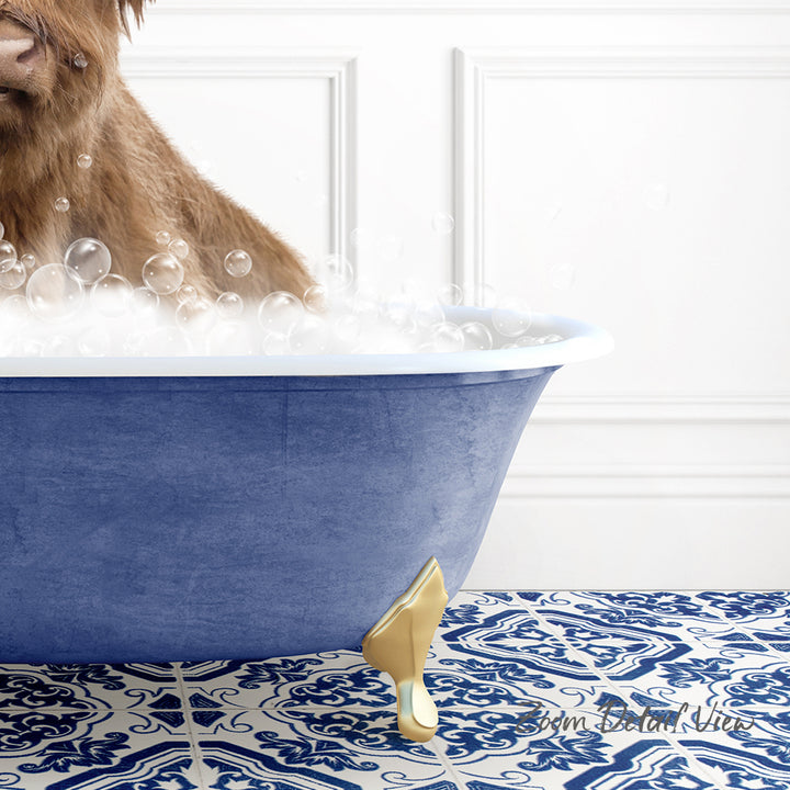 A brown dog is sitting in a blue bathtub filled with bubbles, with a gold bathtub faucet visible.
