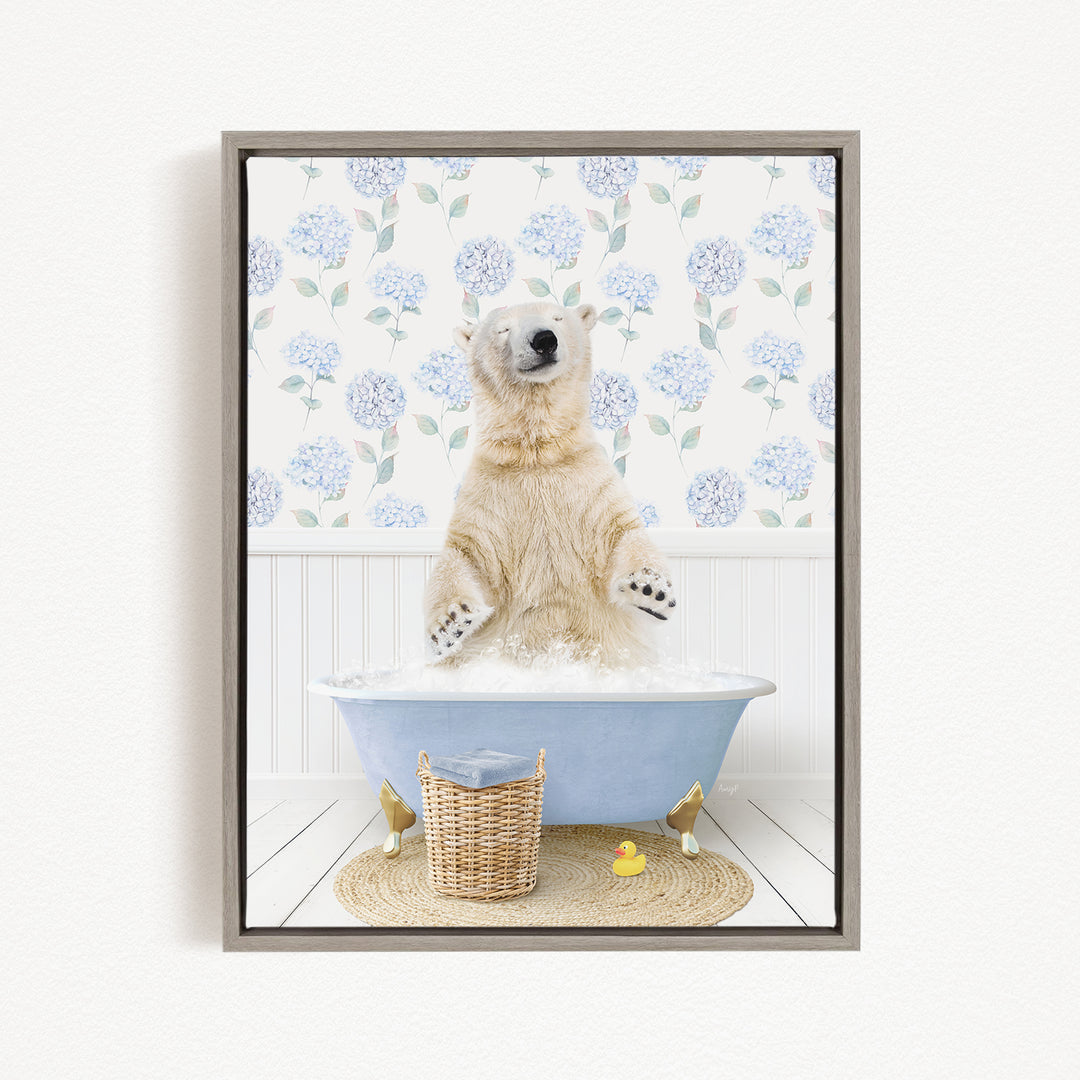 A polar bear is sitting in a blue bathtub filled with water, surrounded by a wicker basket and a rubber duck.