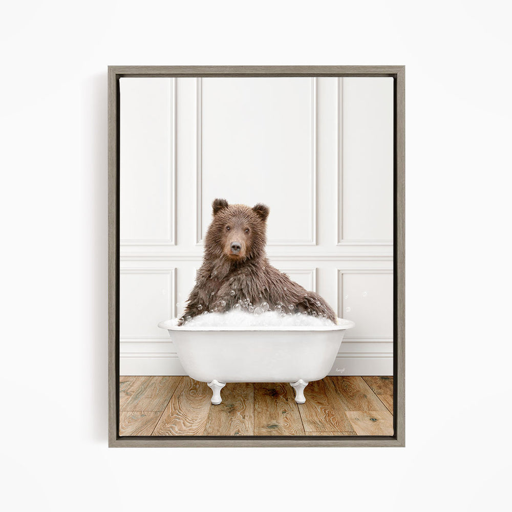 A brown bear sitting in a white bathtub filled with water, looking directly at the camera.