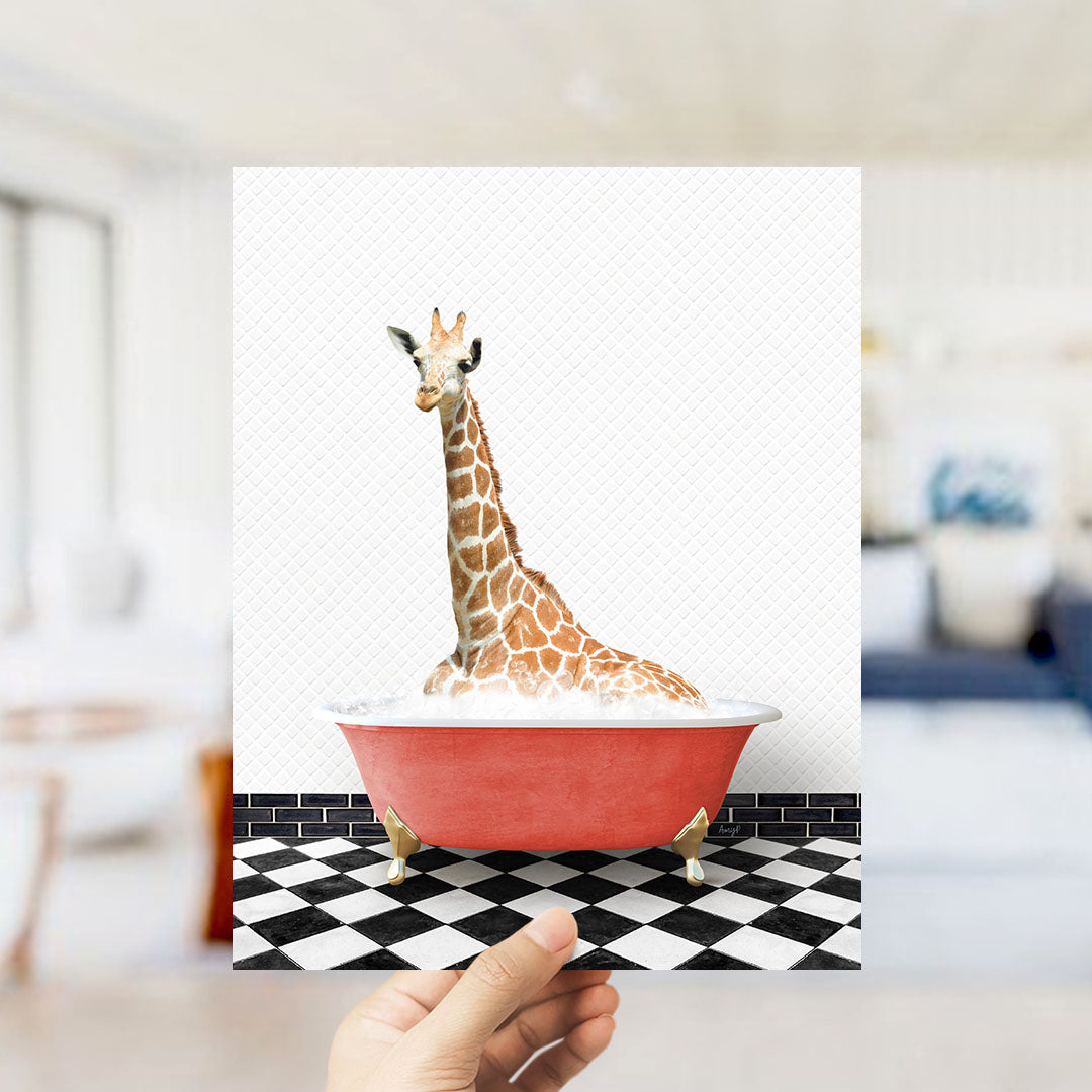 A giraffe sitting in a red bathtub on a black and white checkered floor.