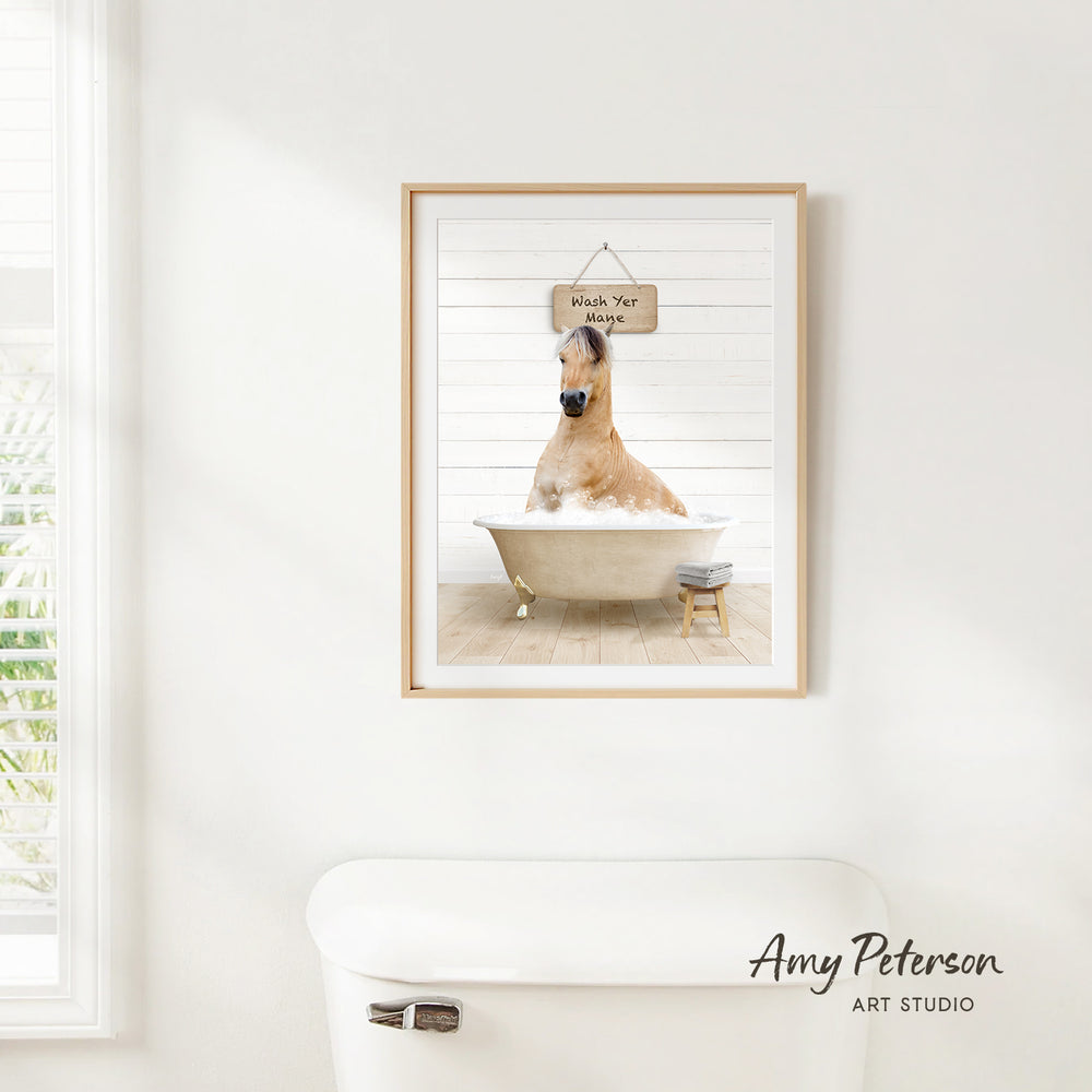 A framed image of a brown horse sitting in a bathtub, with a sign above it that says "Wash Your Horse".