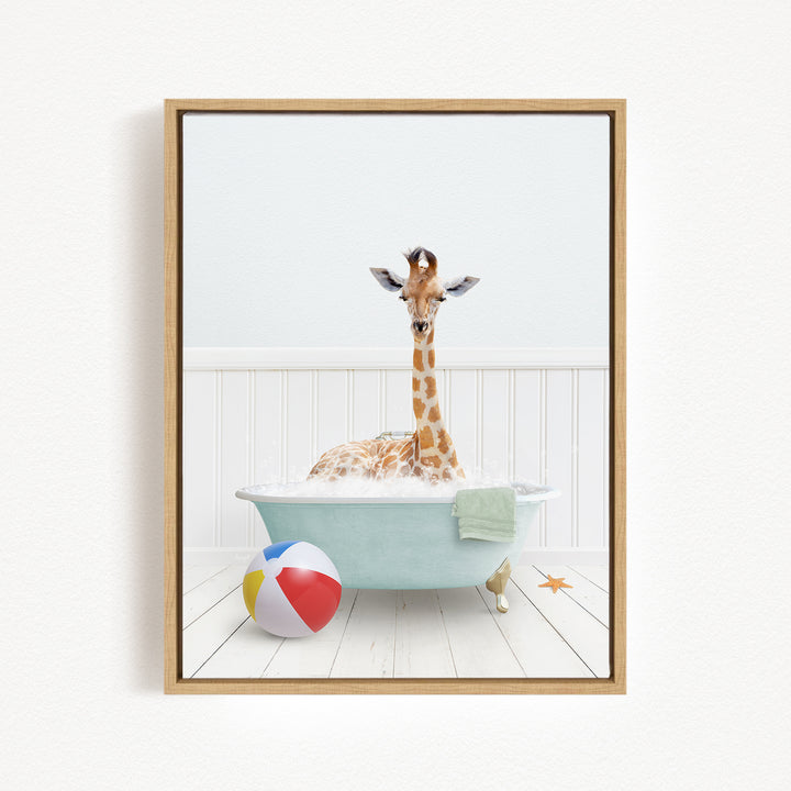 A giraffe is sitting in a bathtub filled with water, surrounded by a beach ball and a towel.
