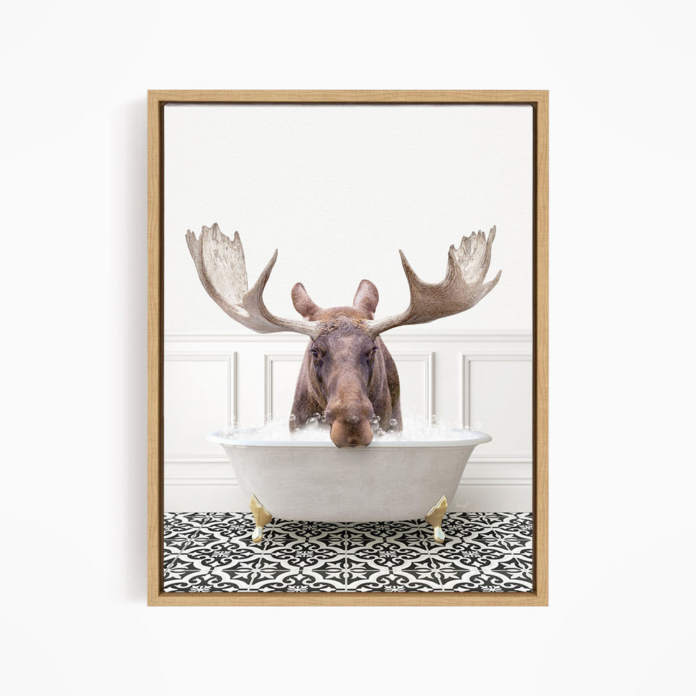 A moose with large antlers is sitting in a bathtub filled with water, creating a whimsical and humorous scene.