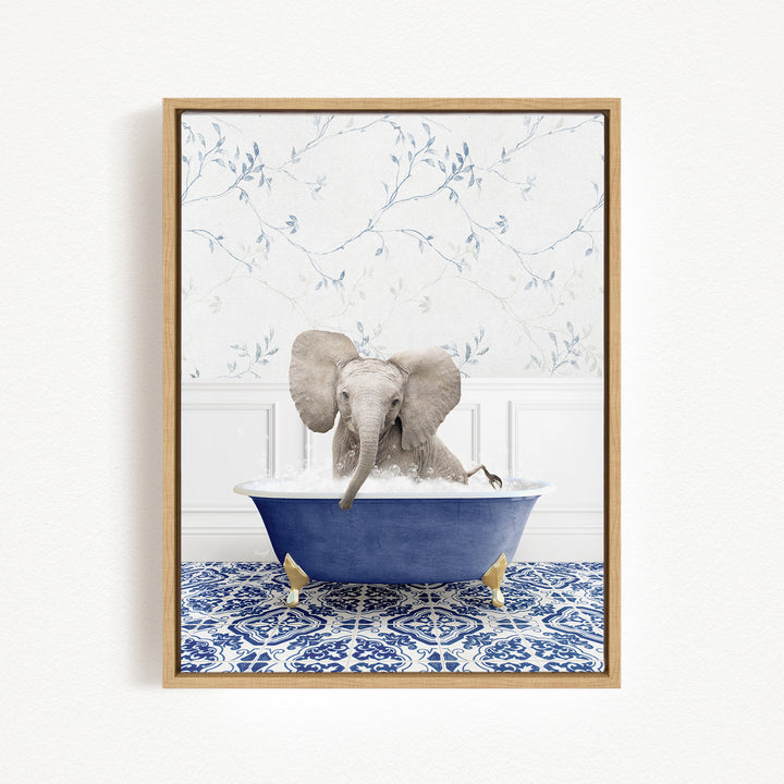 A baby elephant sitting in a blue bathtub filled with water, surrounded by a blue and white patterned tile floor.