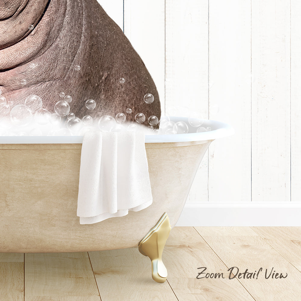 A bathtub filled with bubbles, with a towel hanging on the side and a wooden floor in the background.