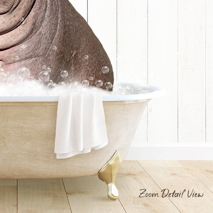 A bathtub filled with bubbles, with a towel hanging on the side and a wooden floor in the background.