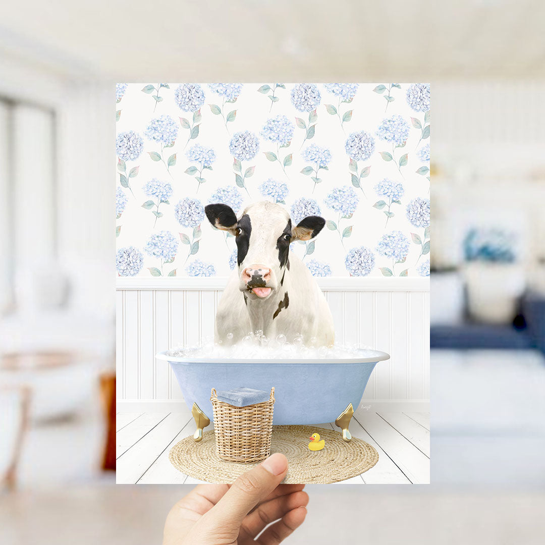 A cow is sitting in a blue bathtub filled with water, surrounded by a floral pattern on the wall behind it.