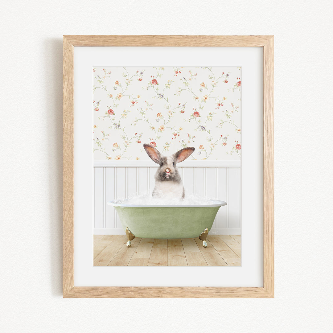 A rabbit sitting in a green bathtub filled with bubbles, with a floral wallpaper in the background.
