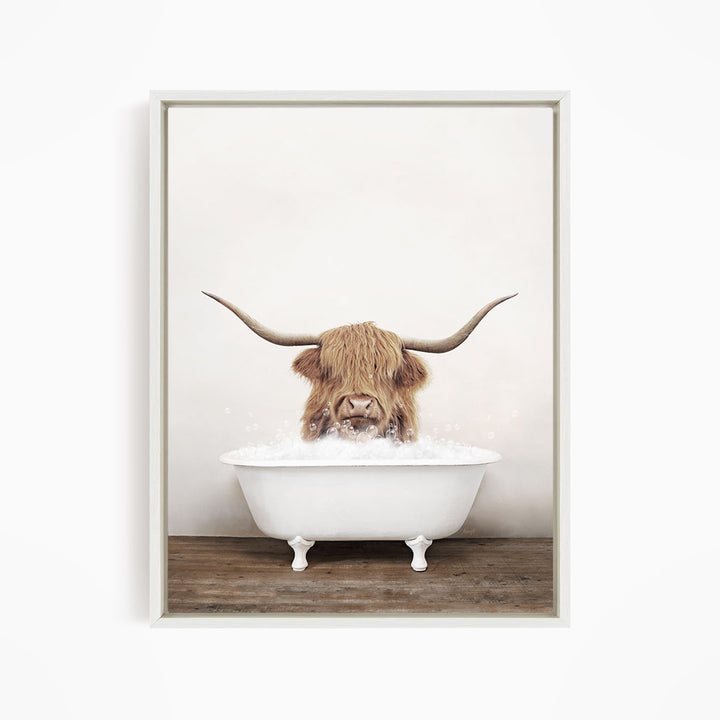 A Highland cow with long horns is sitting in a white bathtub filled with water, creating a whimsical and playful scene.