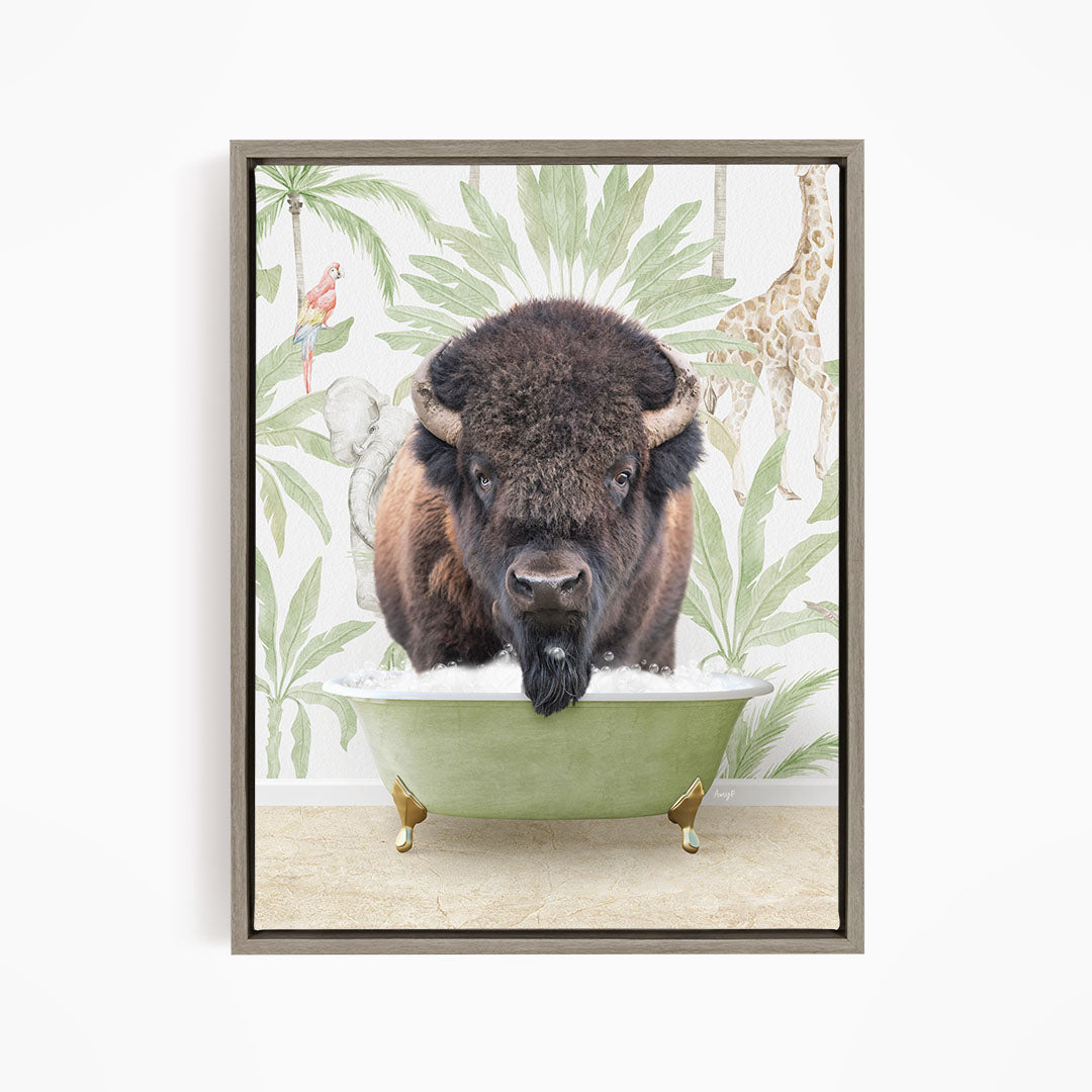 A buffalo is sitting in a green bathtub, surrounded by tropical plants and a giraffe in the background.