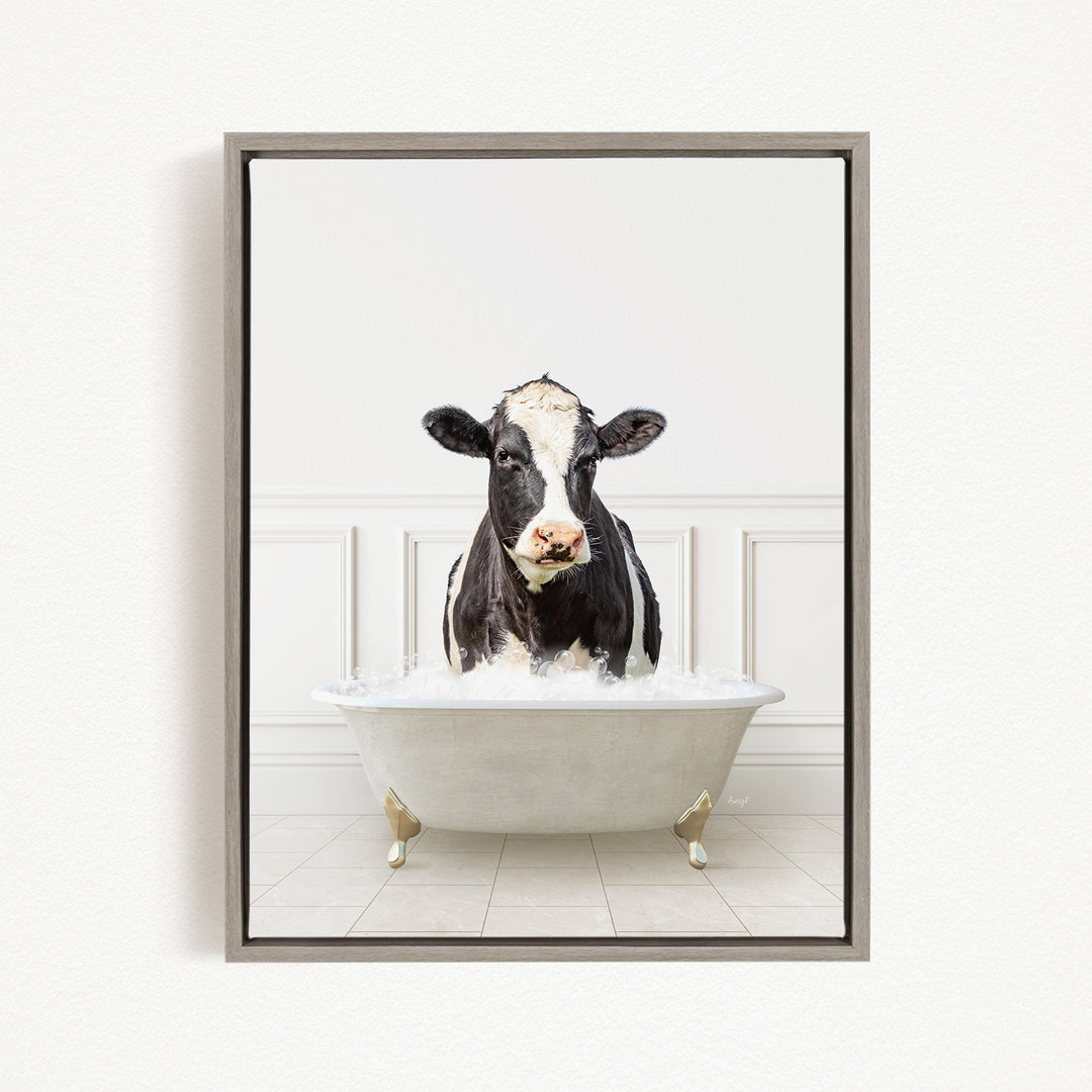 A black and white cow is standing in a white bathtub filled with water, creating a humorous and whimsical scene.