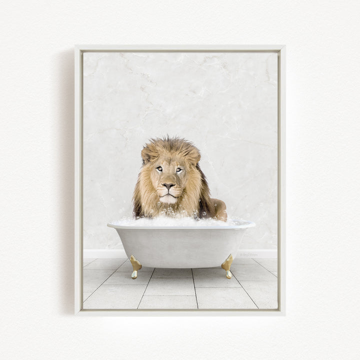 A lion sitting in a white bathtub filled with bubbles, looking directly at the camera.