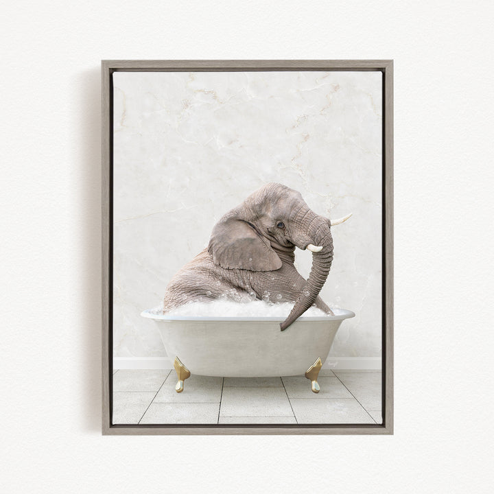 A gray elephant is sitting in a white bathtub filled with water, with its trunk submerged in the water.