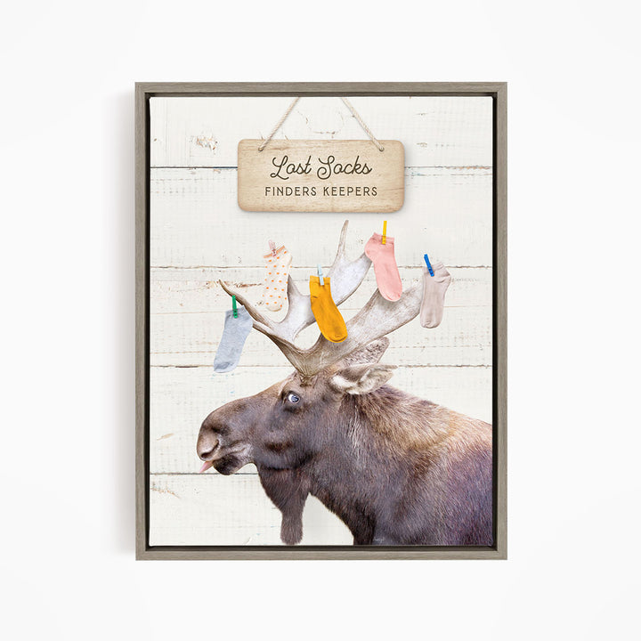 A moose with a sign that says "Last Socks Finders Keepers" hanging above it.