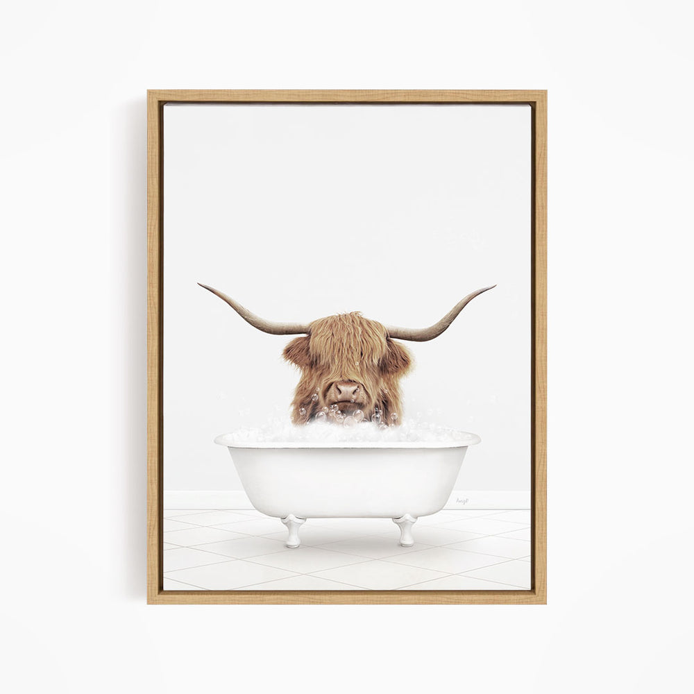 A brown cow with long horns is sitting in a white bathtub filled with water, appearing to enjoy the bath.