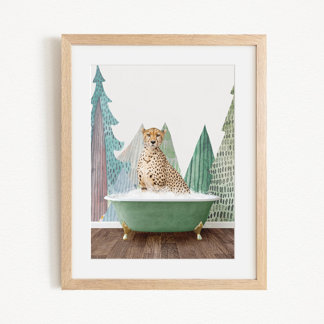 A cheetah is sitting in a green bathtub, surrounded by trees and mountains in the background.