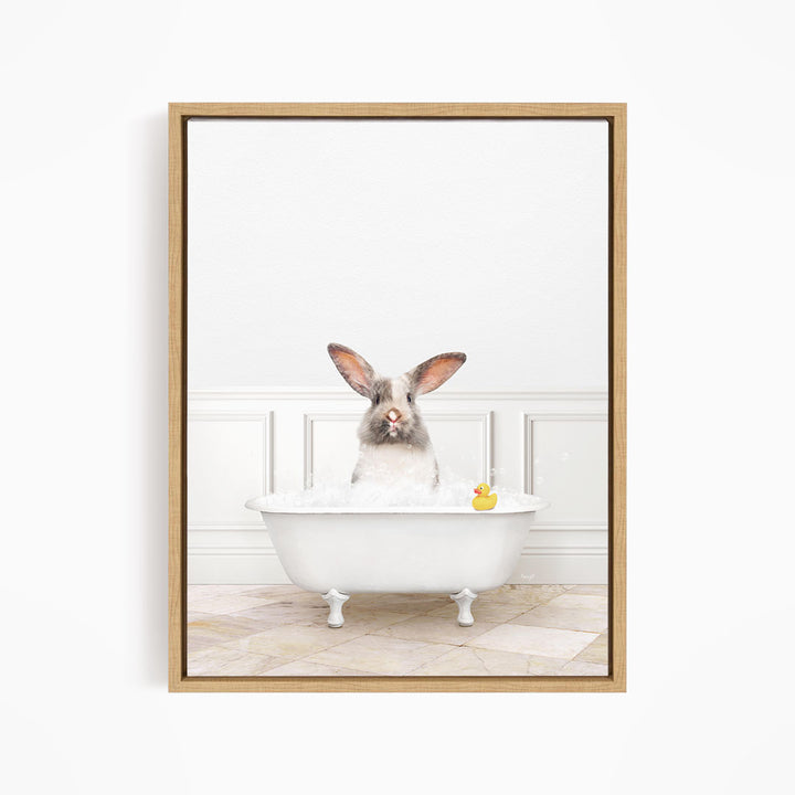 A white rabbit sitting in a white bathtub filled with bubbles, with a rubber duck floating in the water.