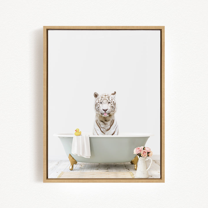 A white tiger sits in a bathtub, surrounded by a yellow rubber duck, a white towel, and a vase of pink flowers.