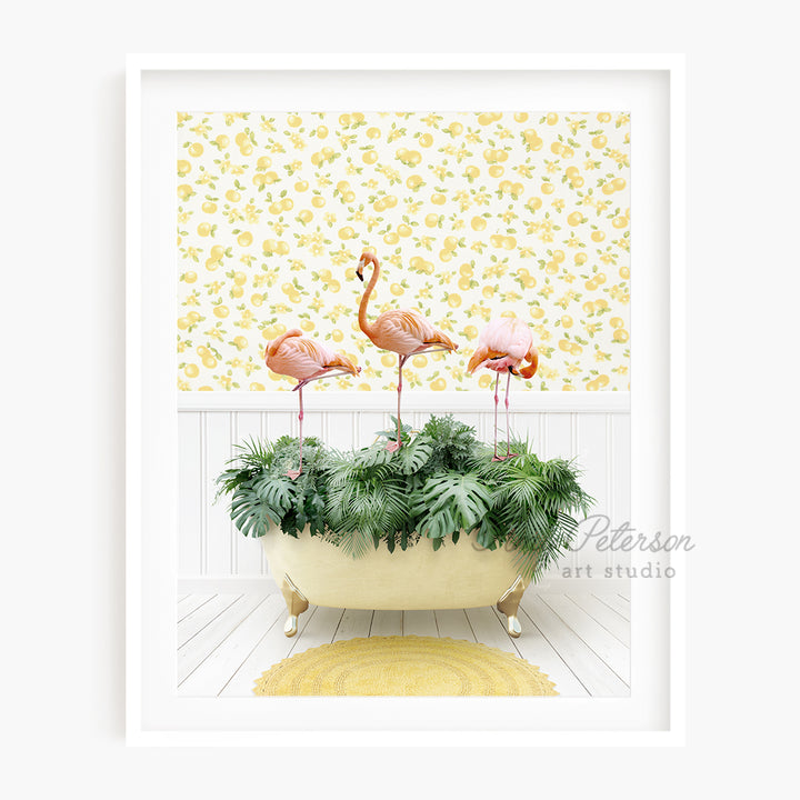 three pink flamingos are standing in a bathtub