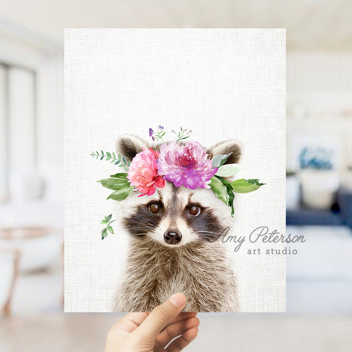 a hand holding a card with a picture of a raccoon wearing a flower