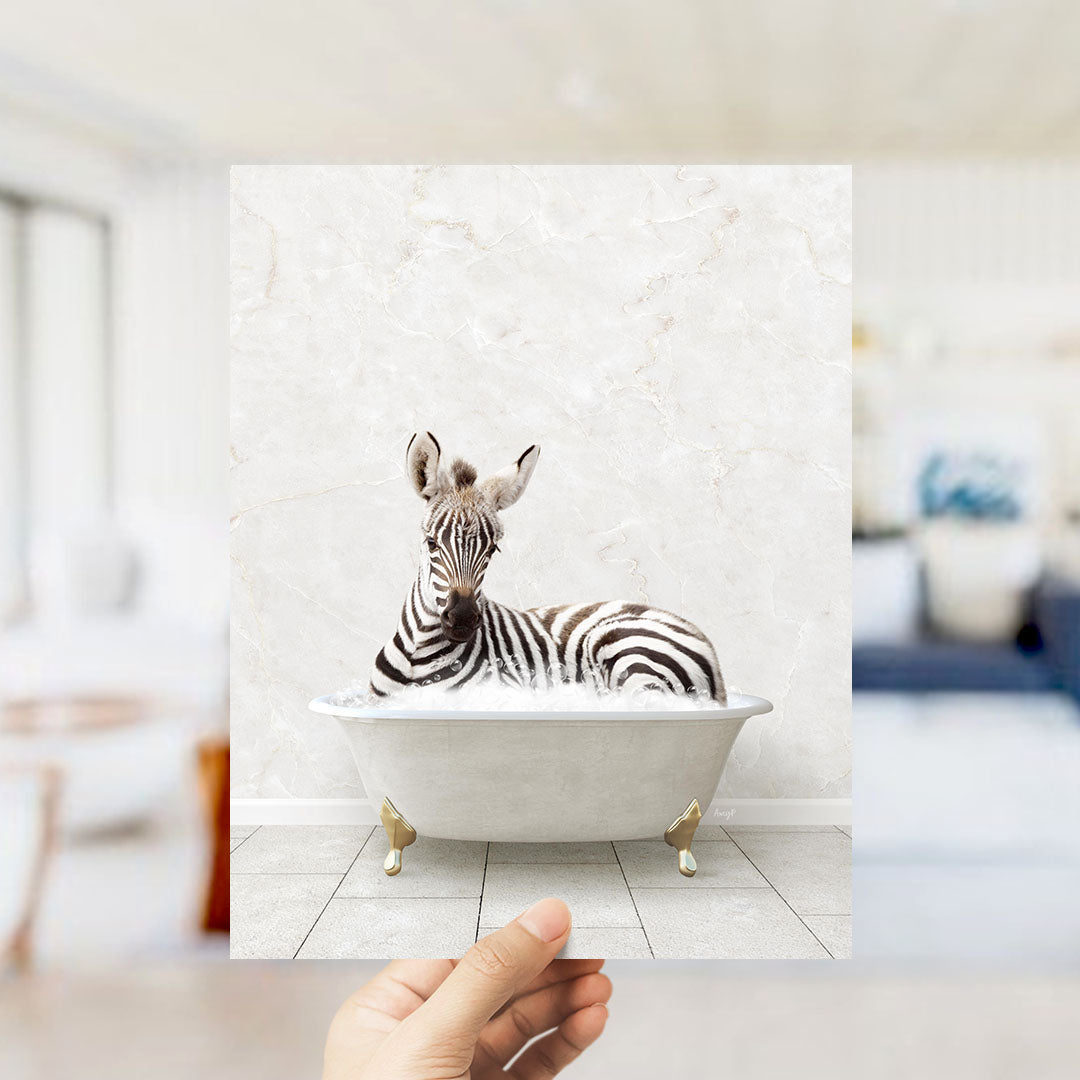 A zebra lying in a white bathtub, surrounded by a white marble wall and a blurred background.
