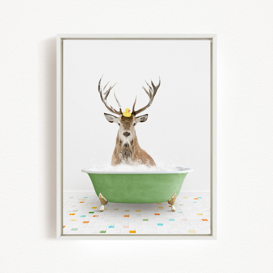 A deer with antlers is sitting in a green bathtub filled with bubbles, with a rubber duck floating on its head.