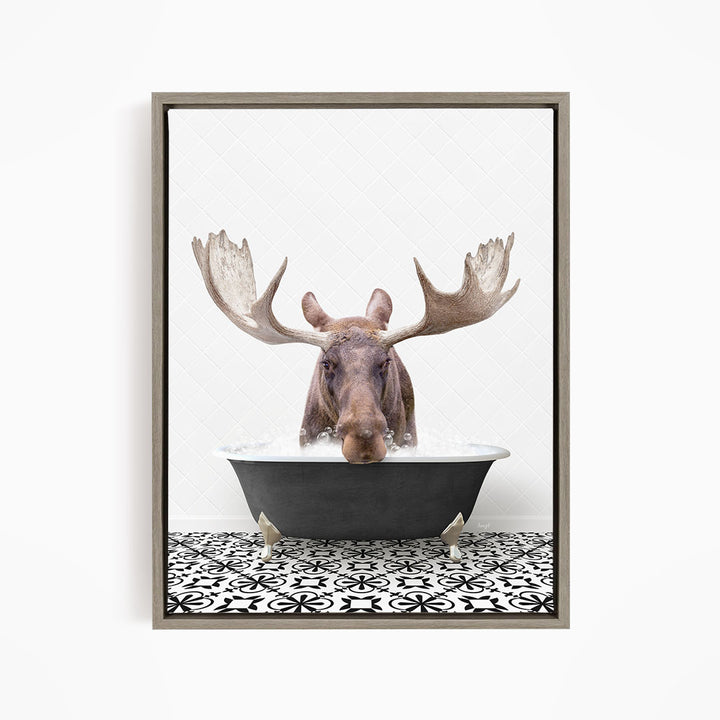 A moose with large antlers is sitting in a bathtub filled with water, creating a whimsical and playful scene.