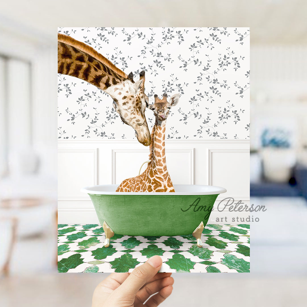 a hand holding a card with two giraffes in a green bowl