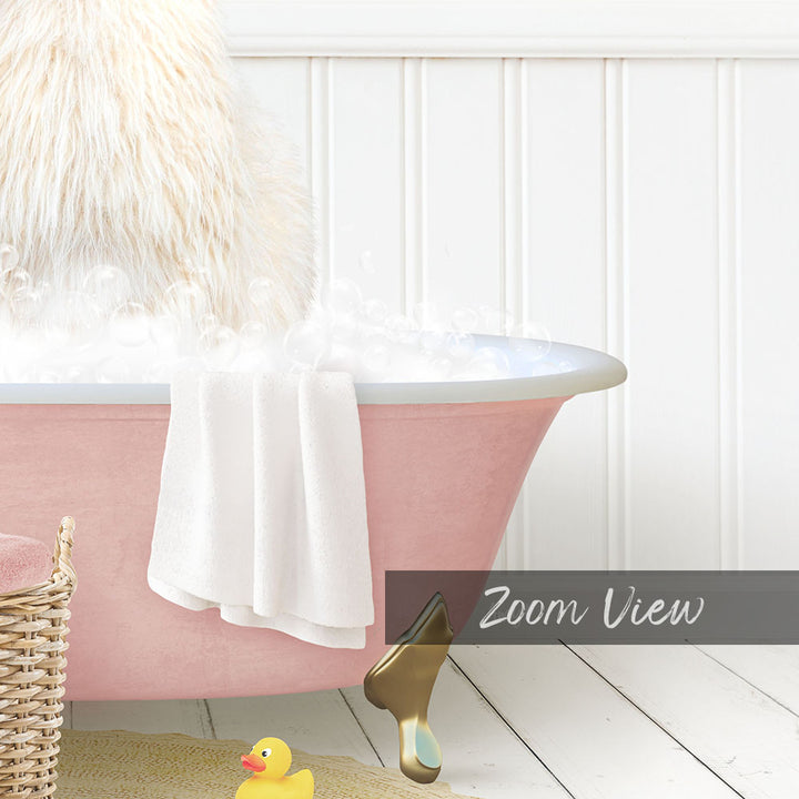 A pink bathtub filled with bubbles, with a white towel and a yellow rubber duck nearby.