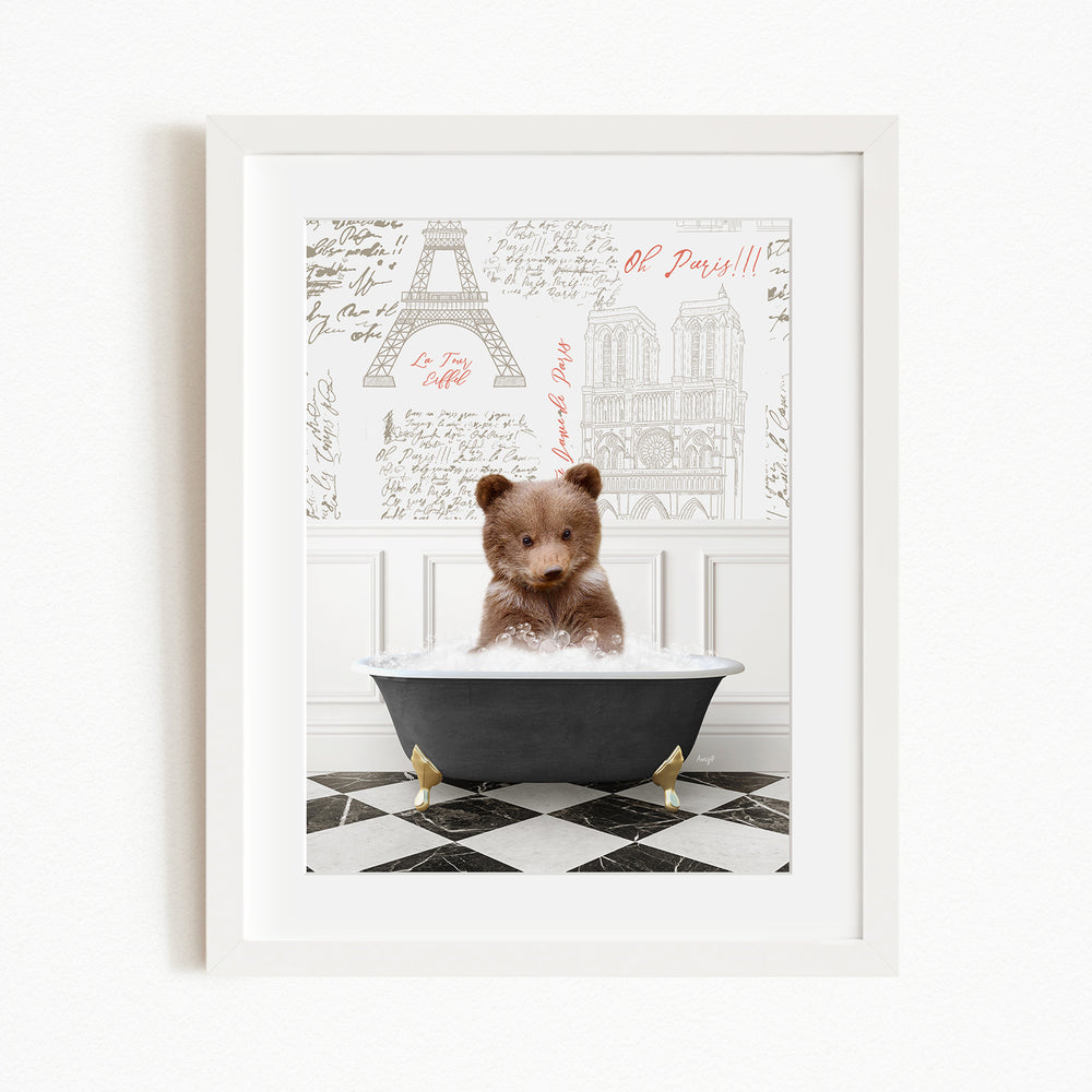 A cute brown bear sitting in a bathtub filled with bubbles, surrounded by a checkered floor and a framed image of the Eiffel Tower in the background.