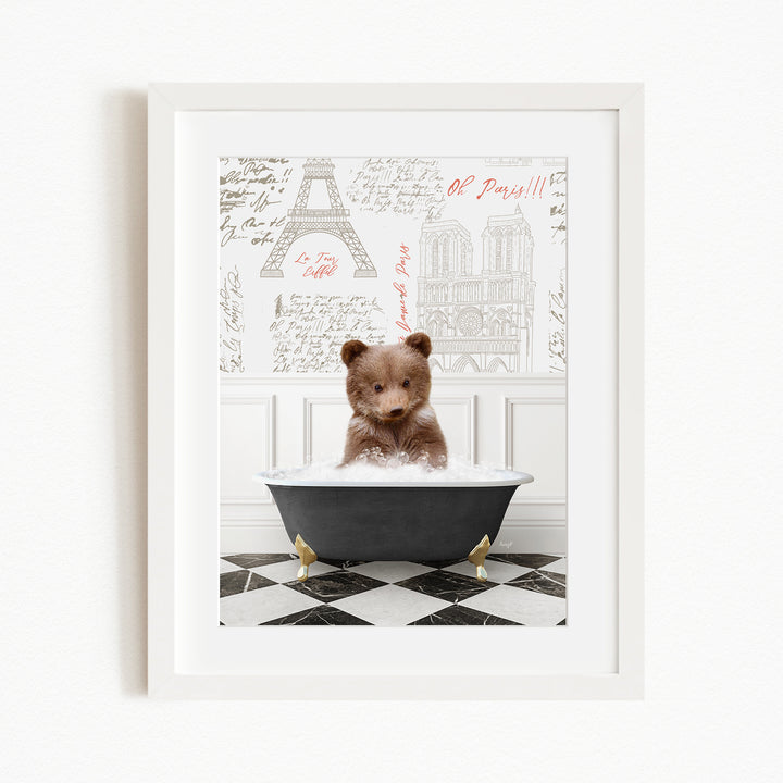 A cute brown bear sitting in a bathtub filled with bubbles, surrounded by a checkered floor and a framed image of the Eiffel Tower in the background.