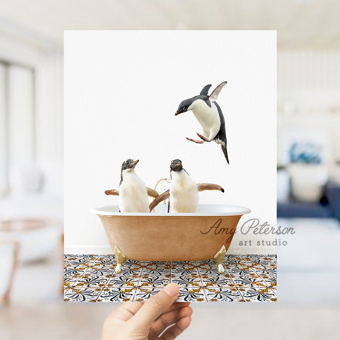 a hand holding a card with three penguins in a bathtub