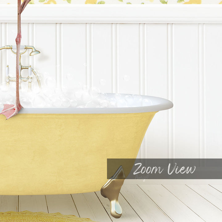 A yellow clawfoot bathtub filled with bubbles, with a pink flower attached to the side, against a white wall with a floral pattern.