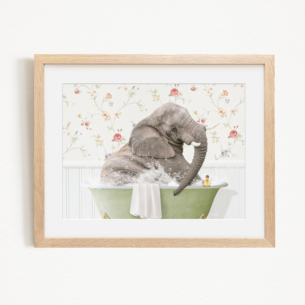 A gray elephant is sitting in a green bathtub filled with water, surrounded by a floral patterned wall.