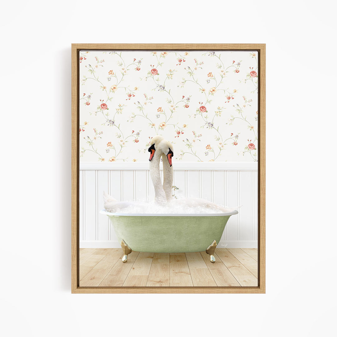 A pair of swans sitting in a green bathtub, with a floral wallpaper in the background.