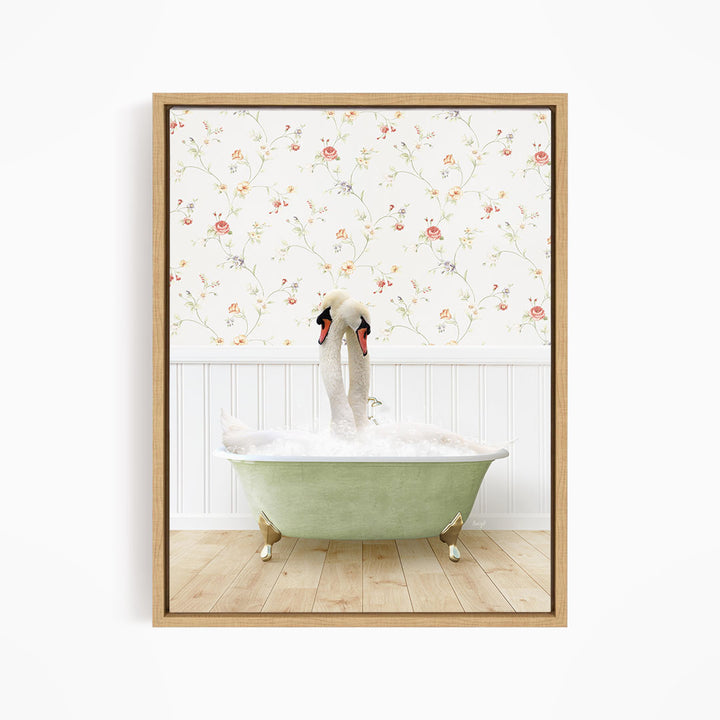 A pair of swans sitting in a green bathtub, with a floral wallpaper in the background.